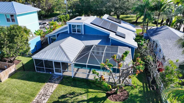 an aerial view of a house with a yard and garden