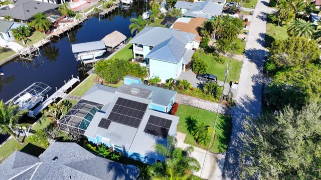 an aerial view of a house with a yard