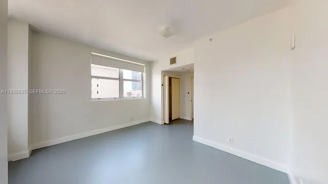 a view of an empty room with a window