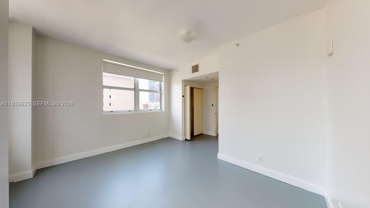 111 East Flagler Street, Unit 810 Miami, FL 33131 - Photo 12 of 19 an empty room with windows