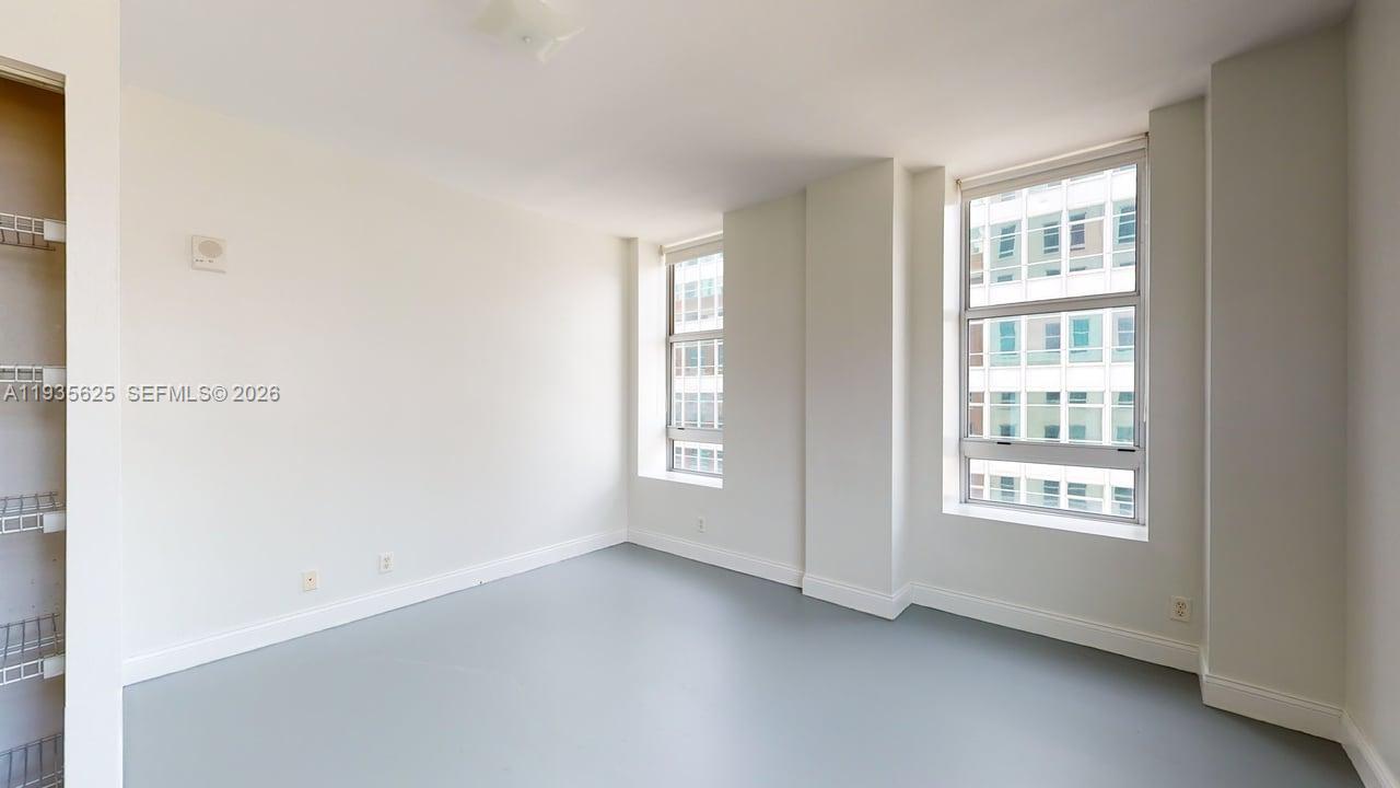 111 East Flagler Street, Unit 810 Miami, FL 33131 - Photo 13 of 19 a view of an empty room with a window