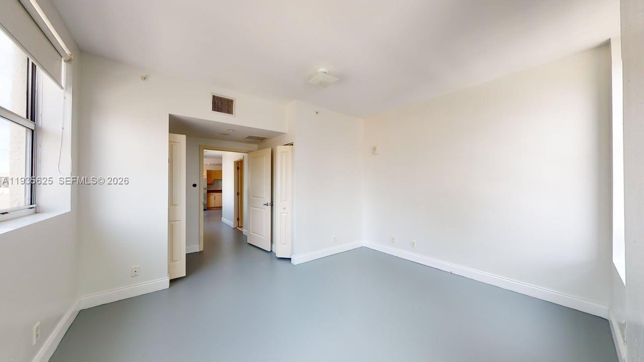 111 East Flagler Street, Unit 810 Miami, FL 33131 - Photo 14 of 19 a view of a small space with wooden floor and a window