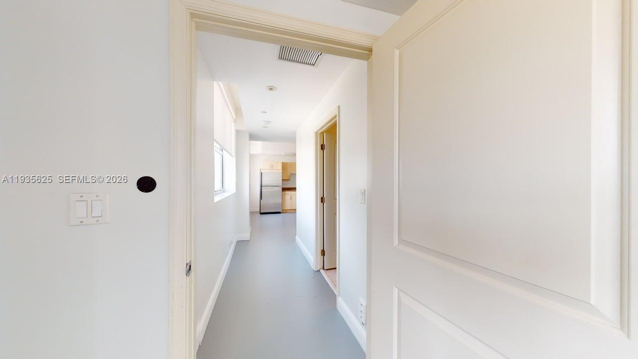 111 East Flagler Street, Unit 810 Miami, FL 33131 - Photo 15 of 19 a view of a hallway with a wooden floor