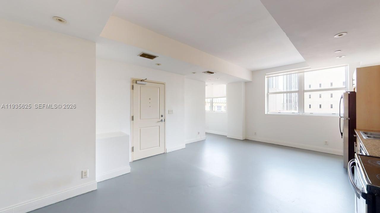 111 East Flagler Street, Unit 810 Miami, FL 33131 - Photo 7 of 19 a view of an empty room with a window