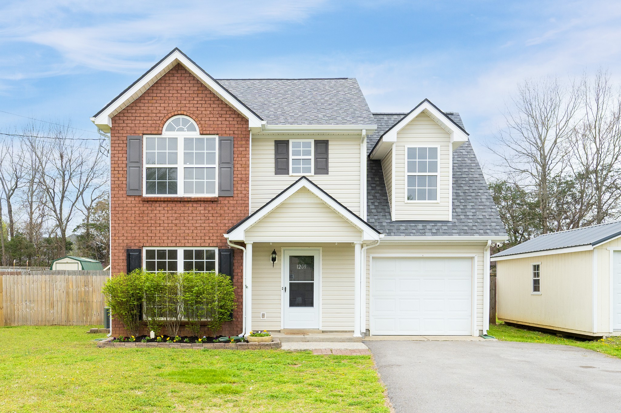 a front view of a house with a yard and garage