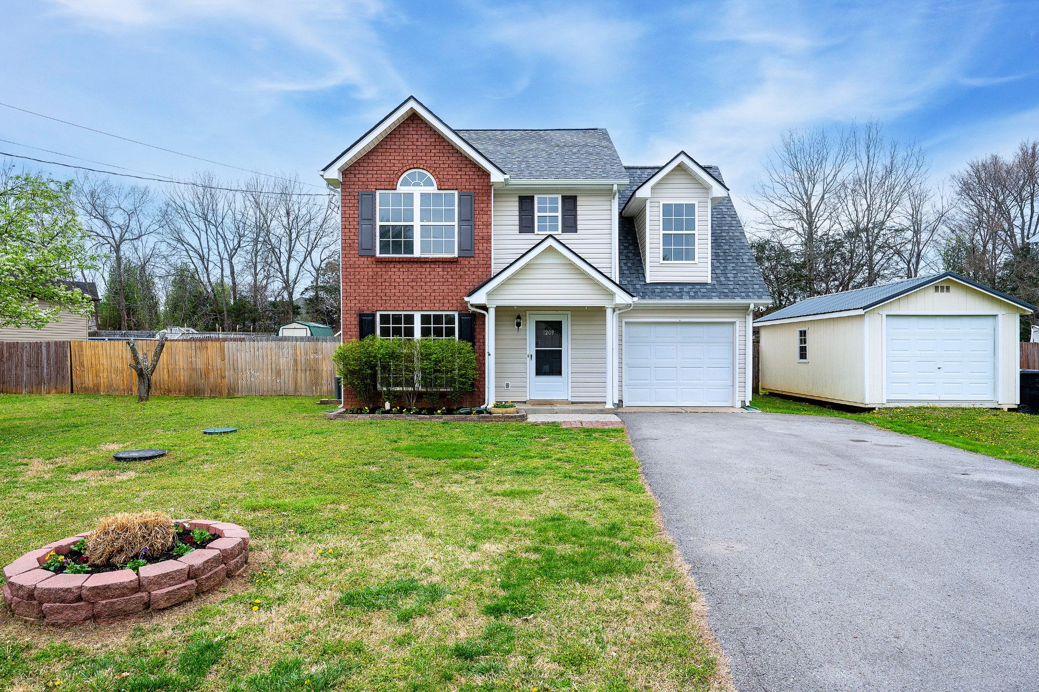 1209 Fall Parkway Murfreesboro, TN 37129 - Photo 22 of 22 a front view of a house with a yard and garage