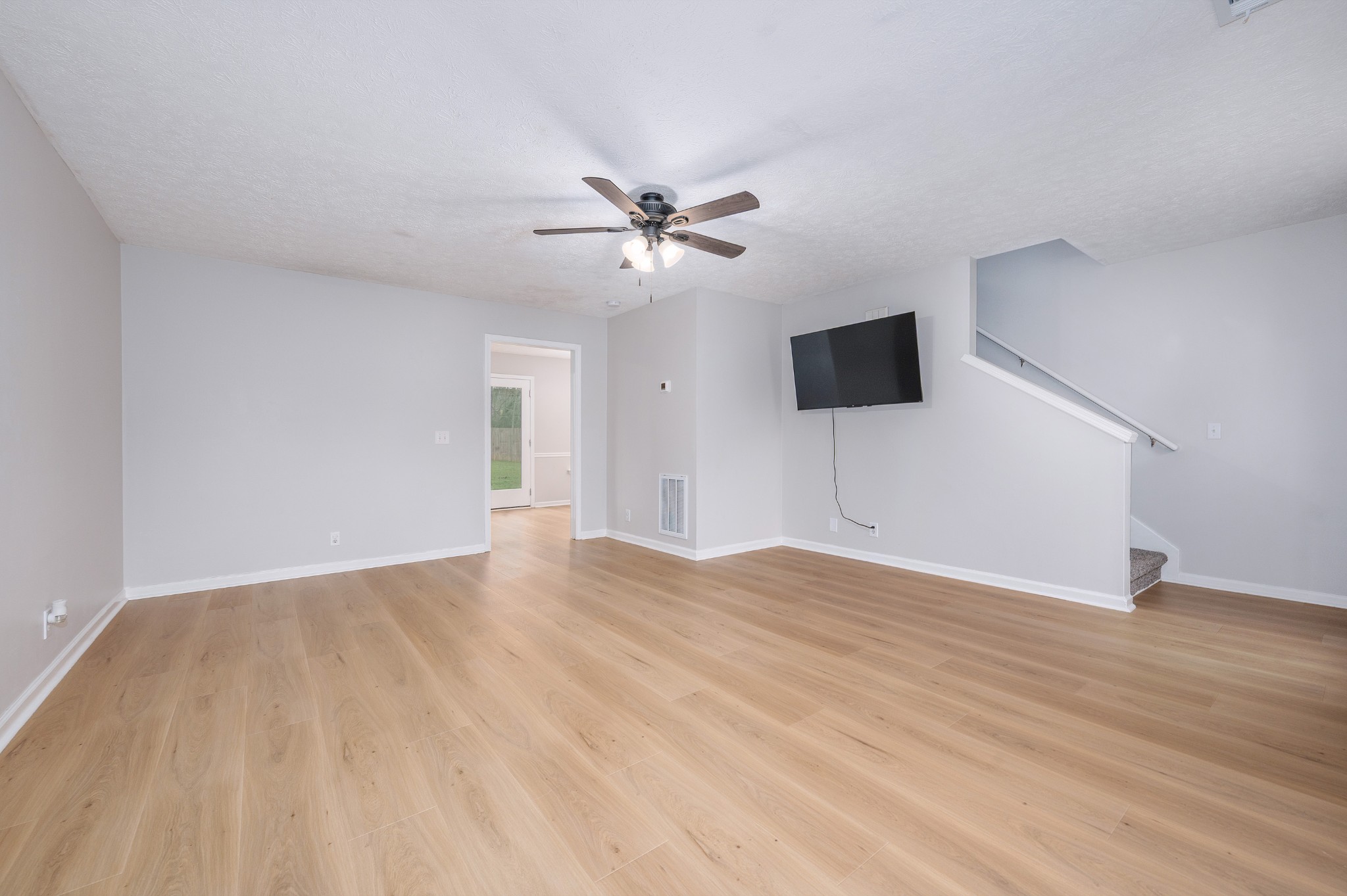 1209 Fall Parkway Murfreesboro, TN 37129 - Photo 3 of 22 a view of an empty room with wooden floor and a ceiling fan