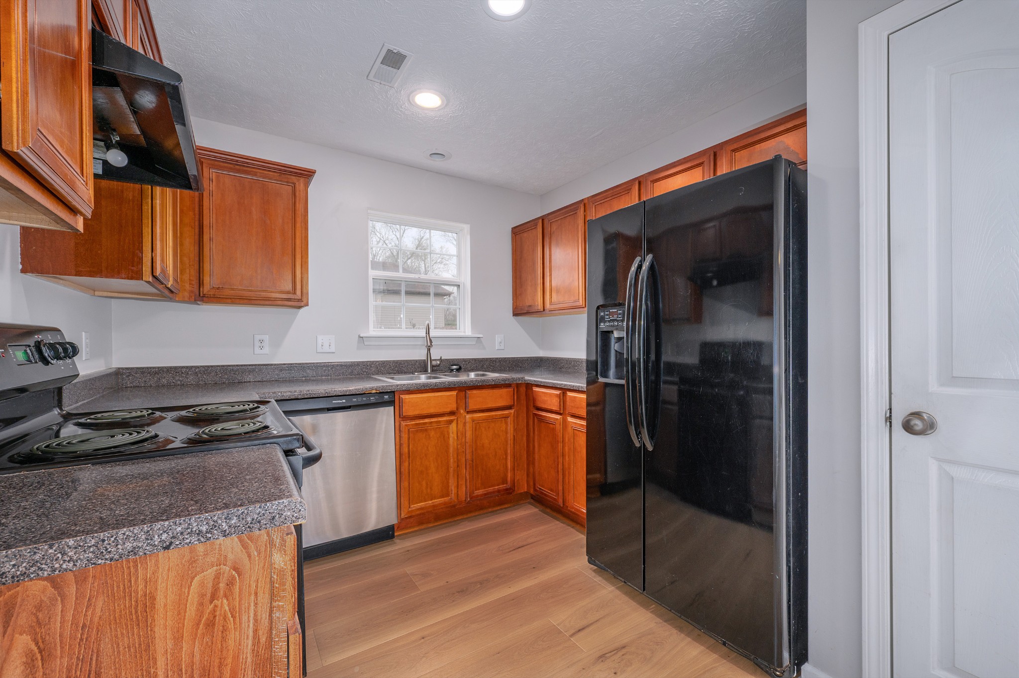 1209 Fall Parkway Murfreesboro, TN 37129 - Photo 4 of 22 a kitchen with stainless steel appliances granite countertop a stove a sink and a refrigerator
