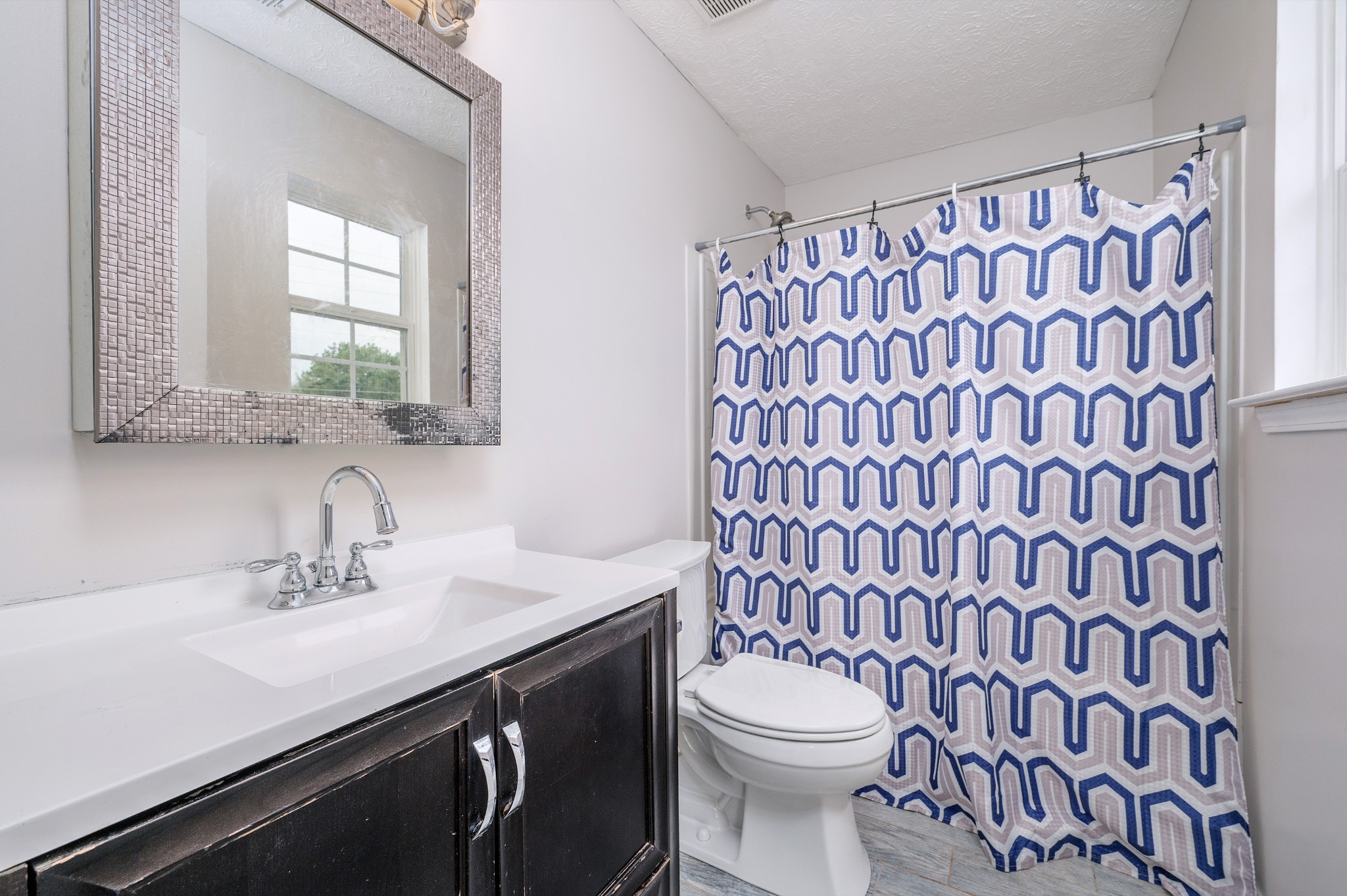 1209 Fall Parkway Murfreesboro, TN 37129 - Photo 10 of 22 a bathroom with a sink a toilet and shower curtain