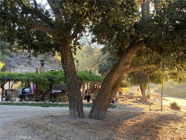 a view of a house with backyard porch and sitting area