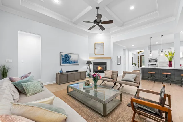 a living room with furniture a fireplace and a chandelier