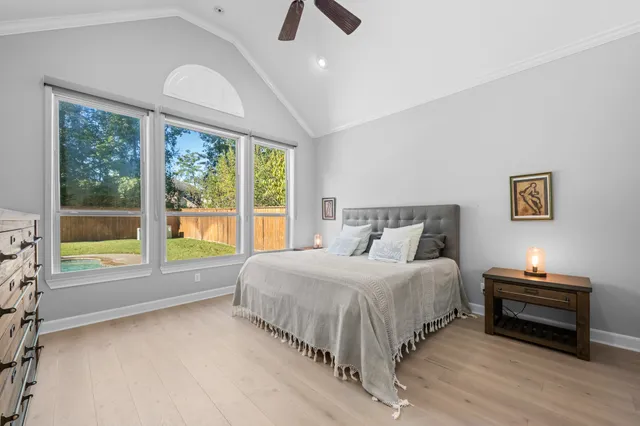 a bedroom with a bed and a large window