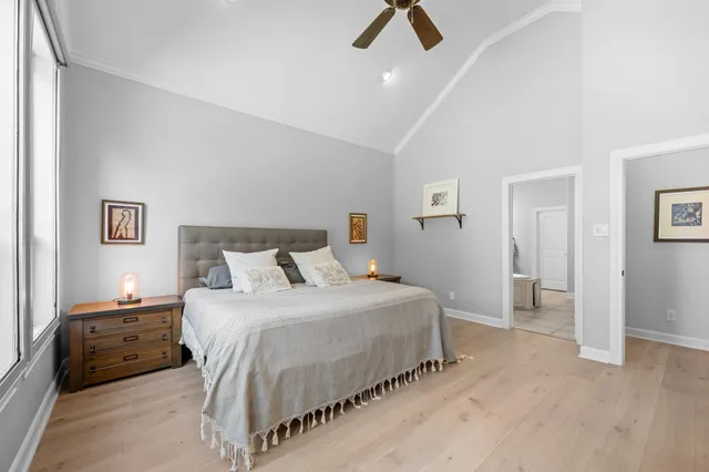 a bedroom with a bed and a chandelier