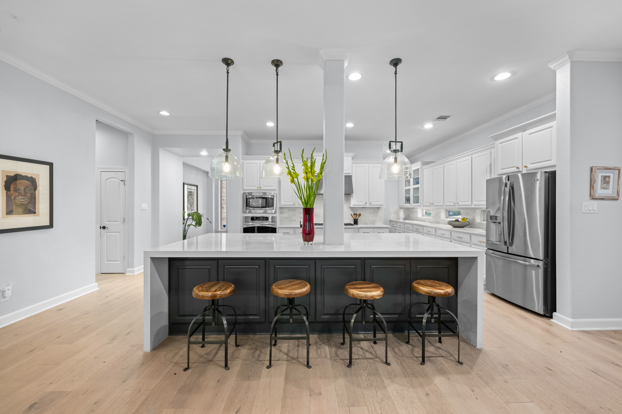 27 Fury Ranch Place Tomball, TX 77375 - Photo 17 of 47 a kitchen with stainless steel appliances kitchen island granite countertop a dining table chairs and white cabinets
