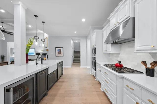 a kitchen with kitchen island granite countertop a sink stove and cabinets