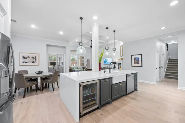 a large white kitchen with lots of counter space and sink