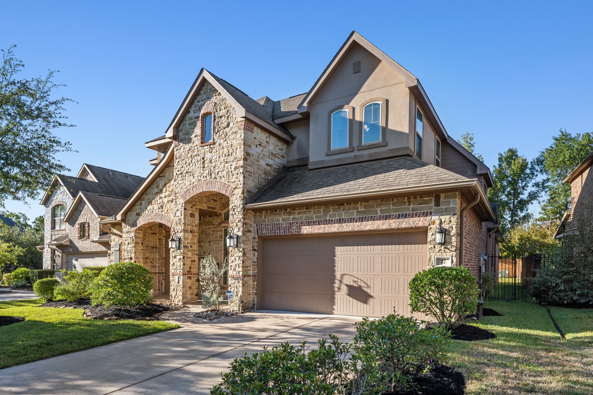 27 Fury Ranch Place Tomball, TX 77375 - Photo 2 of 47 a front view of a house with garden