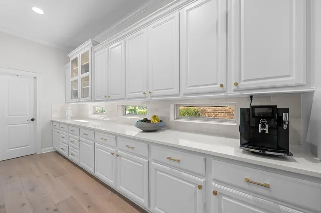 a kitchen with white cabinets and a sink