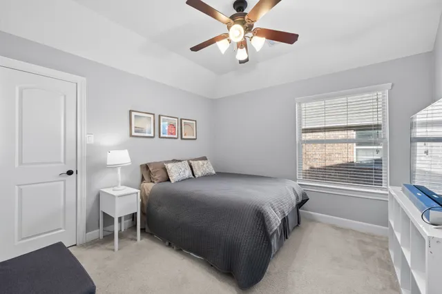 a bedroom with a large bed and a chandelier