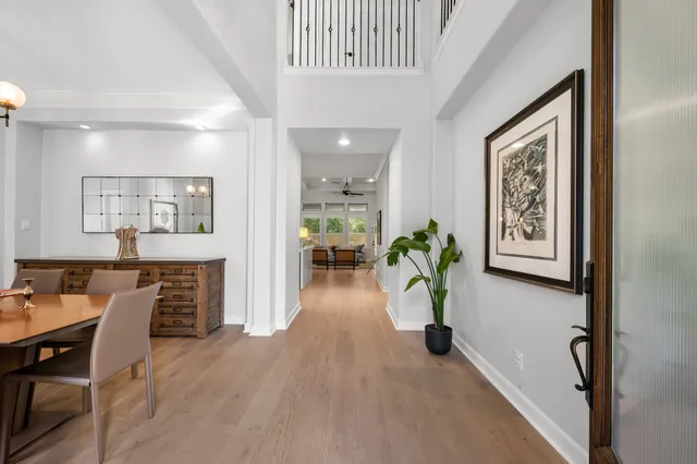 a hallway with furniture and a potted plant