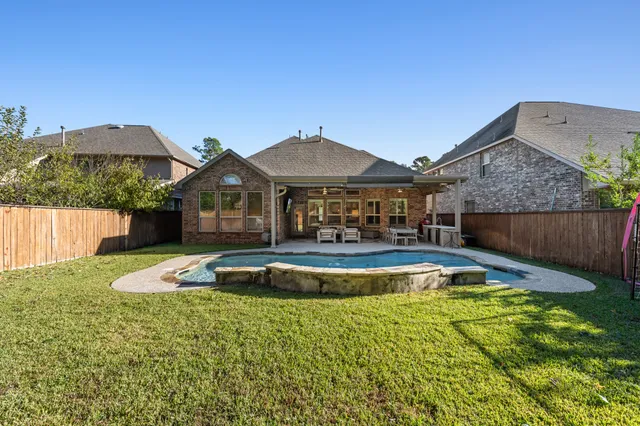a view of a house with pool and chairs