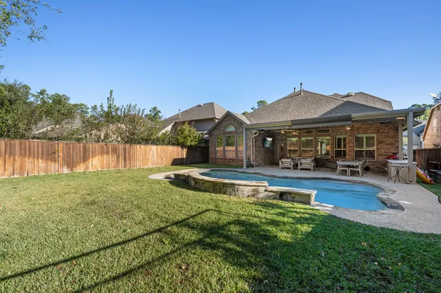 a view of a house with swimming pool and a yard