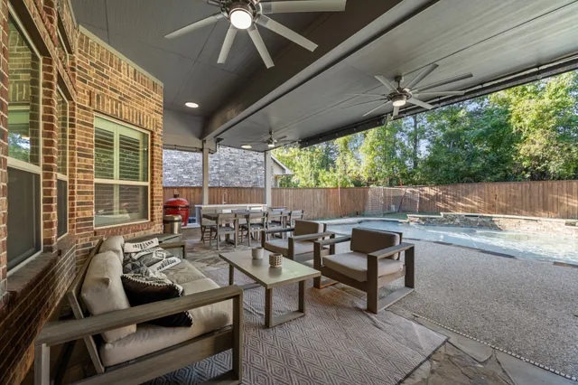 a outdoor space with patio the couches and a dining table with garden view