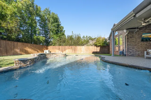 a view of a swimming pool with a patio