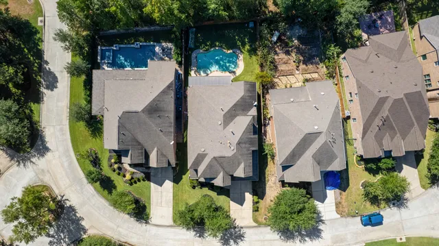 an aerial view of residential building with green space
