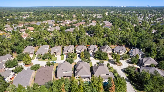 an aerial view of multiple houses with yard