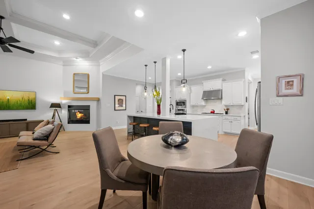 a view of a dining room with furniture and a fireplace