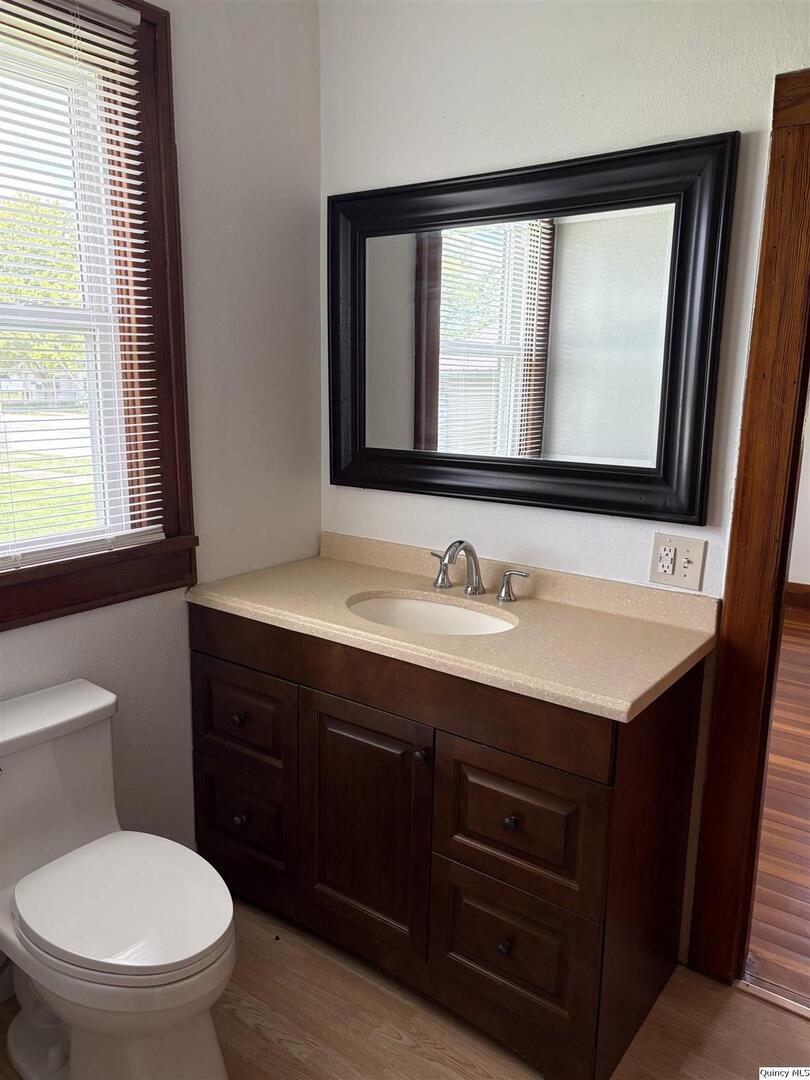101 North Main Timewell, IL 62375 - Photo 11 of 17 a bathroom with a toilet sink vanity mirror and window