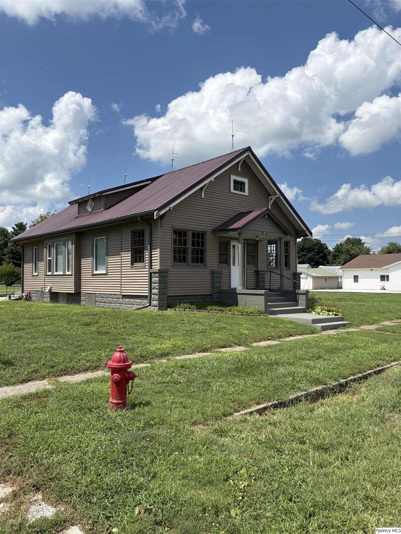 101 North Main Timewell, IL 62375 - Photo 15 of 17 a front view of a house with a yard and garage