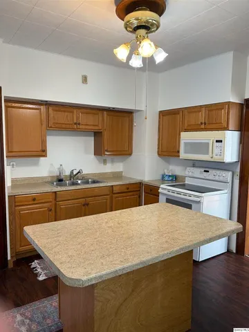 a kitchen with stainless steel appliances granite countertop a sink a stove and microwave