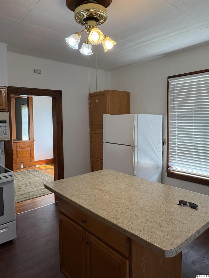 101 North Main Timewell, IL 62375 - Photo 3 of 17 a kitchen with cabinets and wooden floor