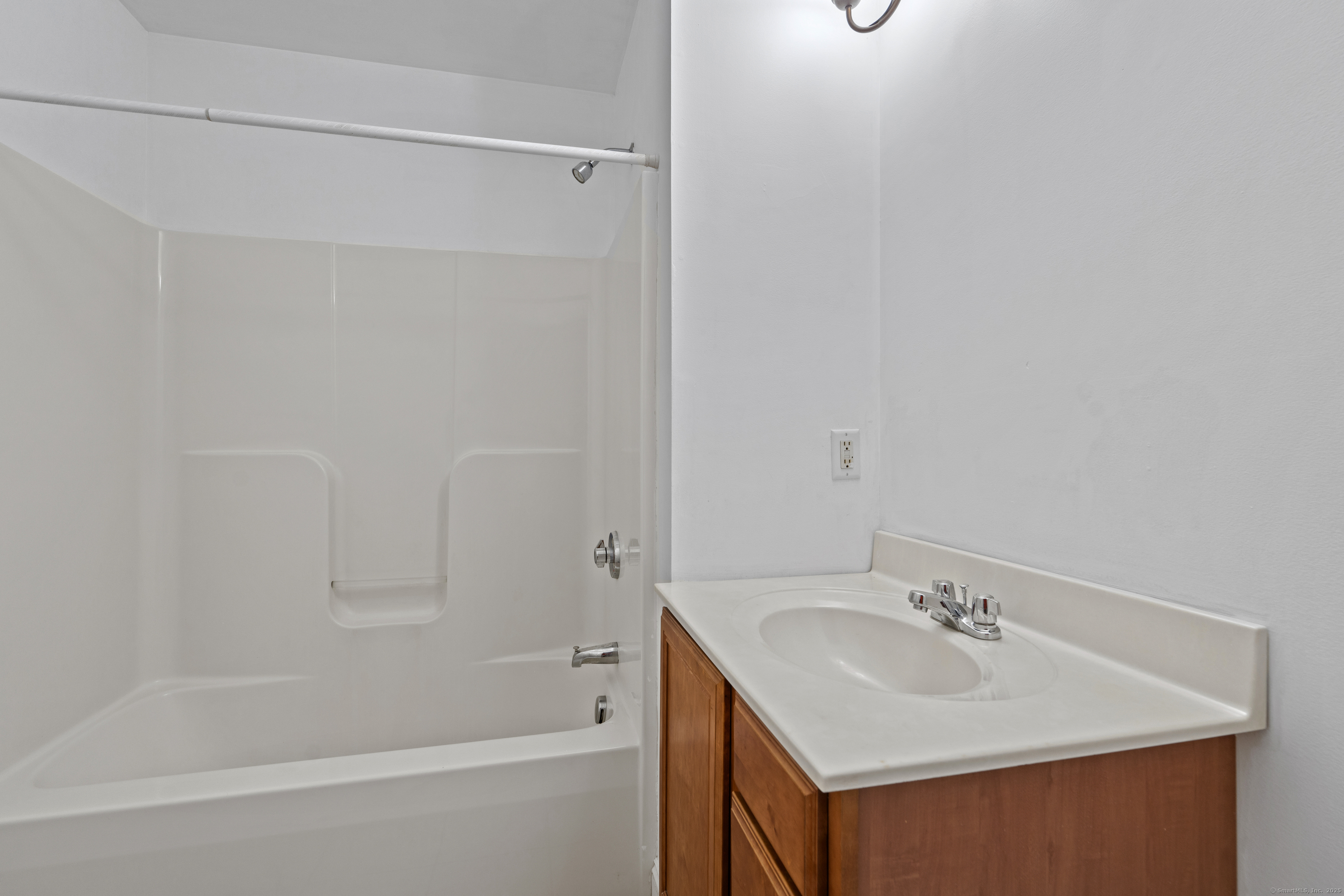 527 West Thames Street, Unit 9 Norwich, CT 06360 - Photo 20 of 25 a bathroom with a sink mirror and a bathtub