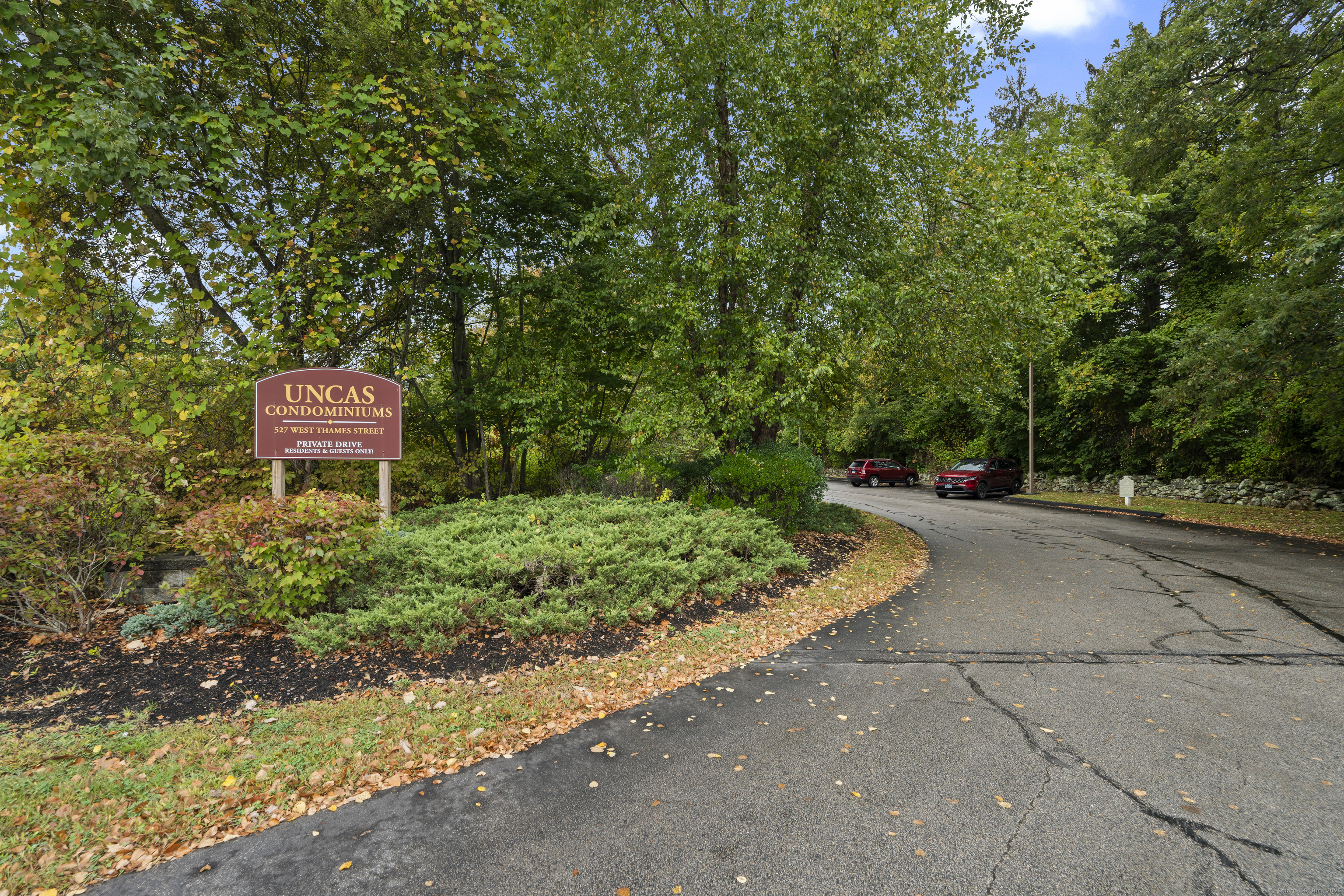 527 West Thames Street, Unit 9 Norwich, CT 06360 - Photo 2 of 25 a sign board with a yard and trees in the background