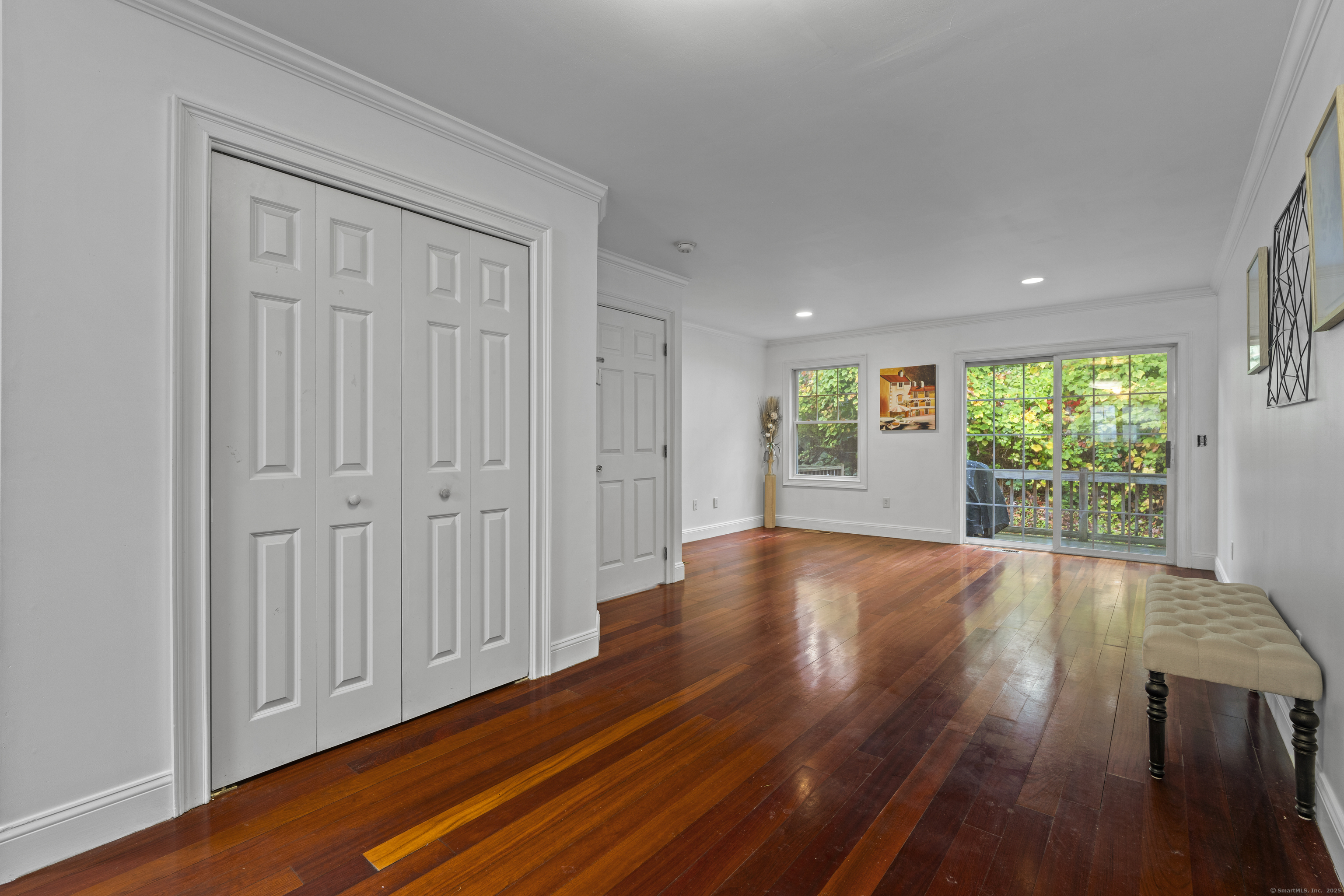 527 West Thames Street, Unit 9 Norwich, CT 06360 - Photo 4 of 25 a view of an empty room with wooden floor and a window