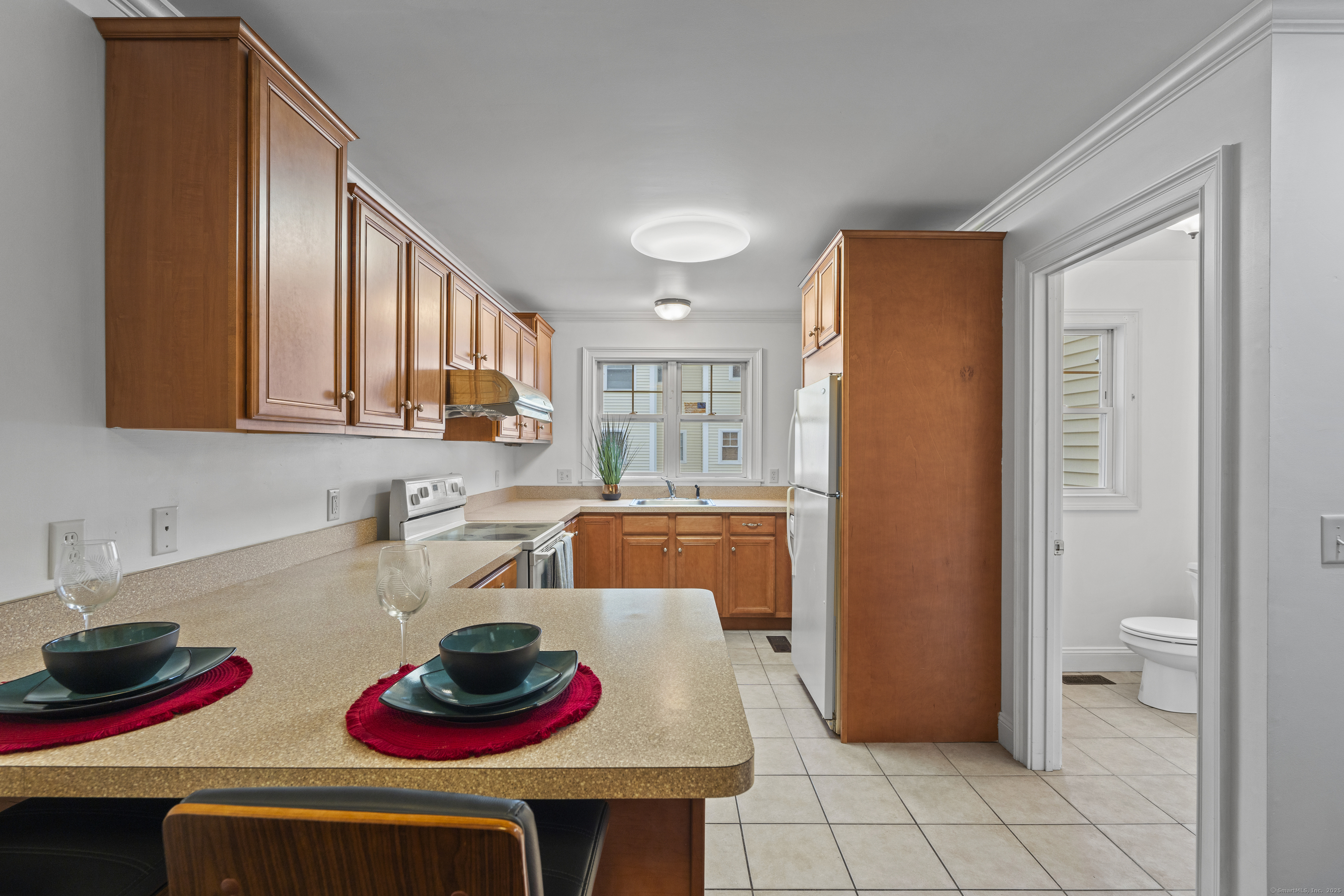 527 West Thames Street, Unit 9 Norwich, CT 06360 - Photo 7 of 25 a kitchen with stainless steel appliances a sink and a refrigerator