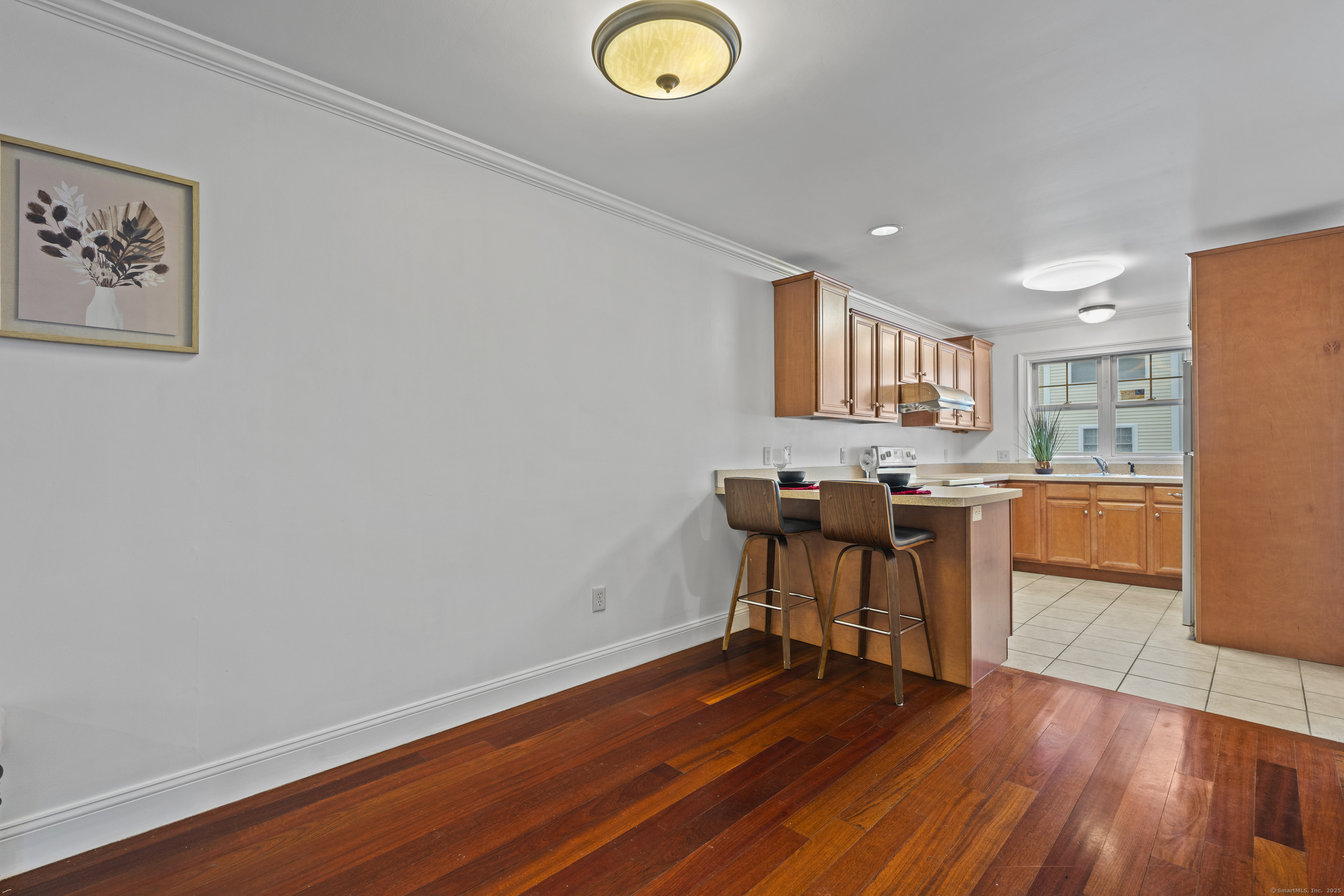 527 West Thames Street, Unit 9 Norwich, CT 06360 - Photo 8 of 25 a view of a workspace with furniture and wooden floor