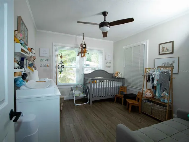 a bedroom with furniture and wooden floor