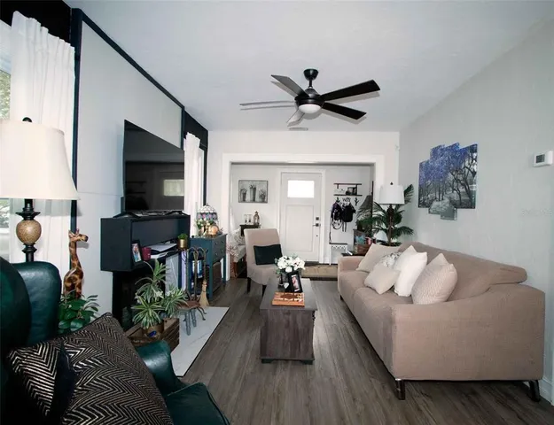 a living room with furniture and a flat screen tv