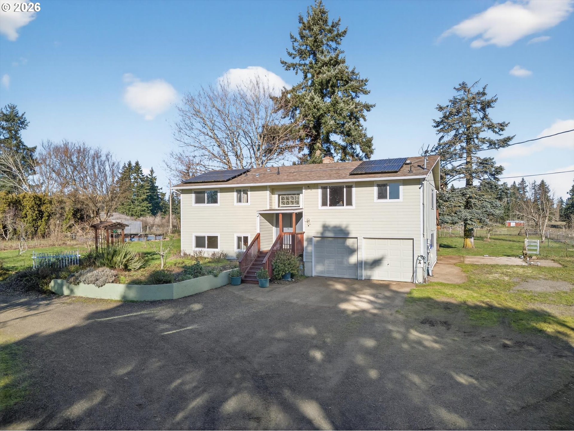a view of a house with a backyard and a tree