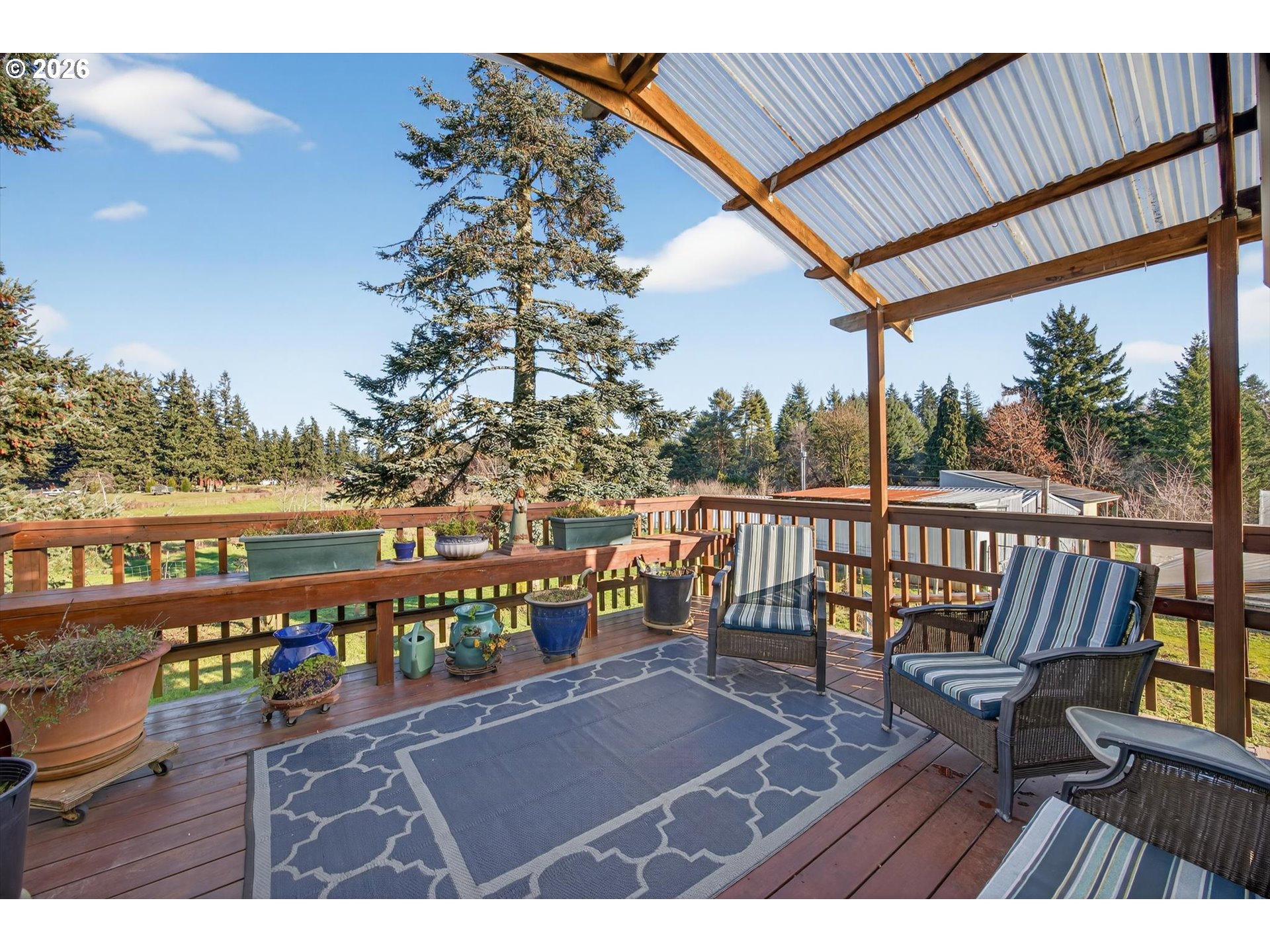 13601 South Union Hall Road Canby, OR 97013 - Photo 15 of 48 a view of a balcony with wooden floor and outdoor seating