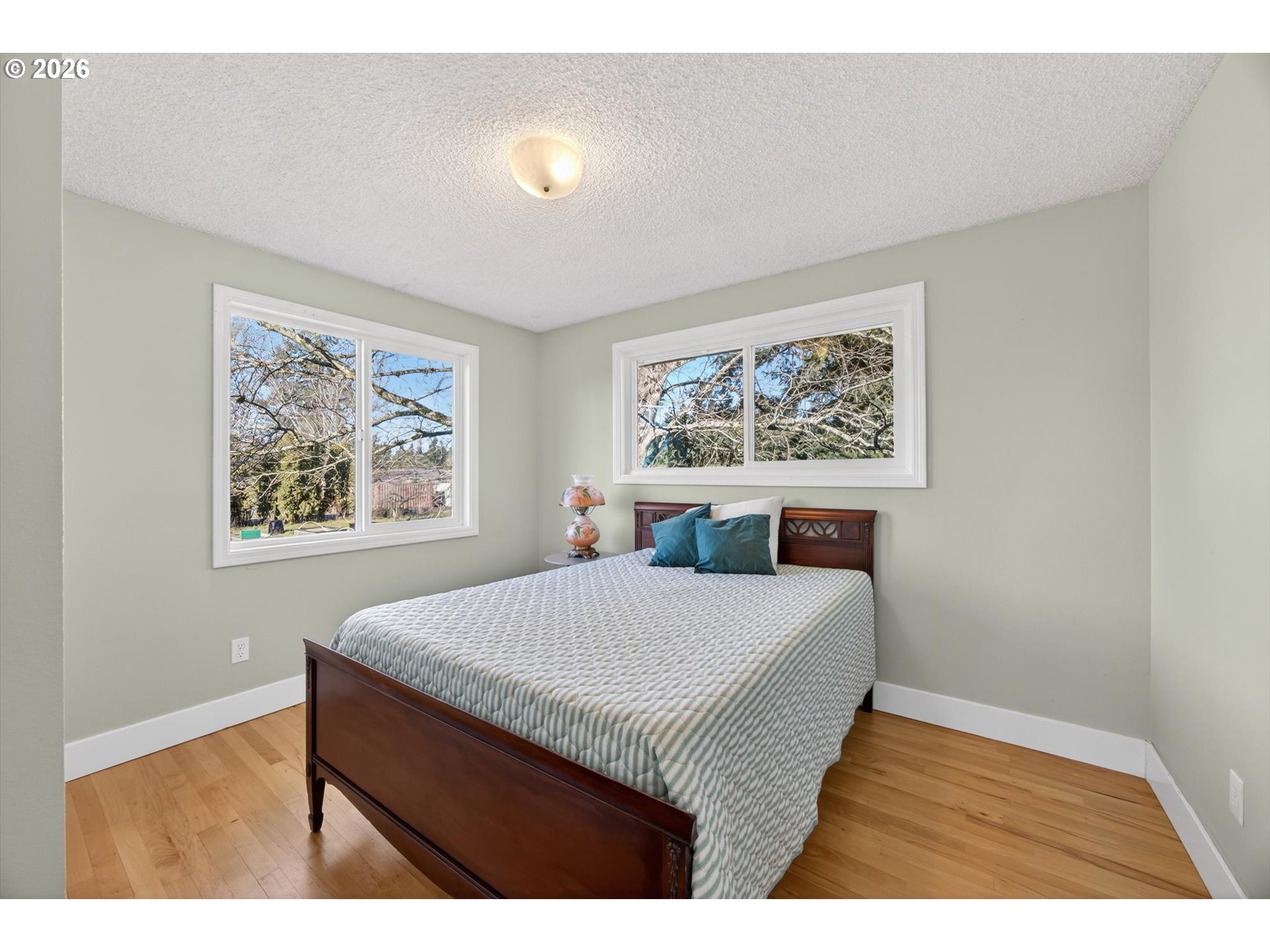 13601 South Union Hall Road Canby, OR 97013 - Photo 21 of 48 a bed sitting in a bedroom next to a window