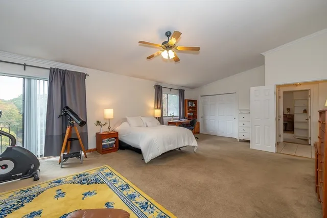 a spacious bedroom with a bed and a chandelier