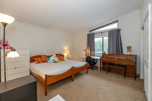 a bedroom with furniture and a window