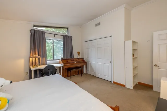 a bedroom with a bed and a large window