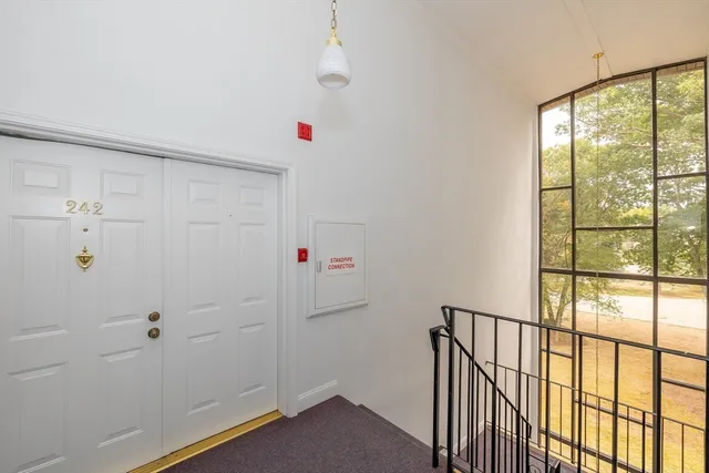 a storage room with wooden floor and windows