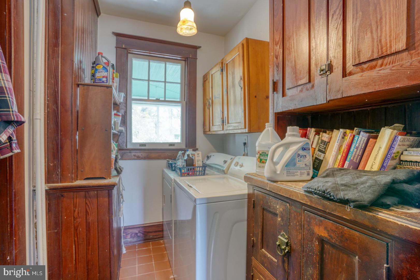 4096 Main Street Trappe, MD 21673 - Photo 31 of 70 a utility room with granite countertop a sink a washer and dryer with wooden cabinet